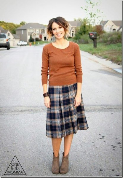 Green fitted scoop neck sweater with midi plaid pleated skirt