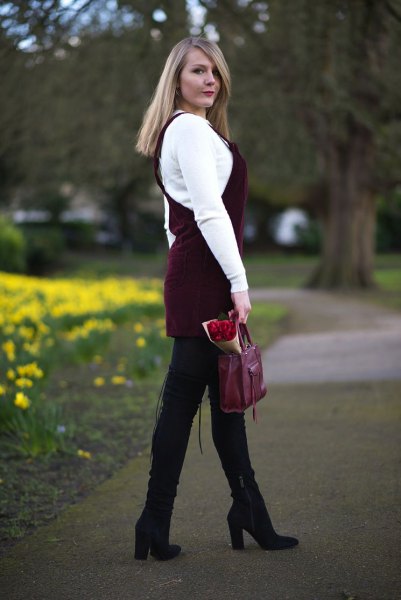 White sweater with black corduroy dress and black overknee boots