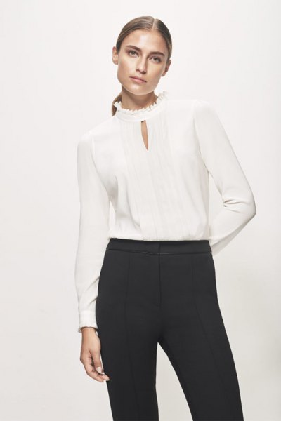 Keyhole silk blouse with high neck and black high-waisted chinos