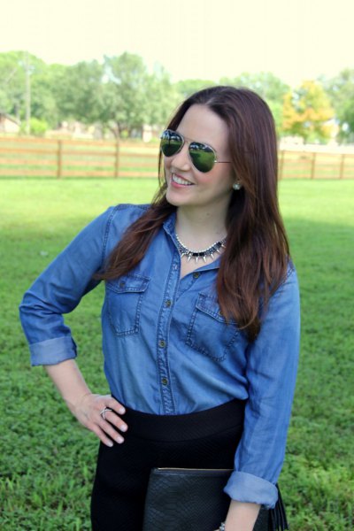 Blue button down chambray shirt and black high waisted jeans