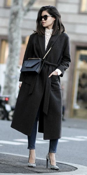 Black walker coat with gray high neck knit sweater and ankle jeans