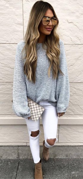 gray thick sweater with white skinny jeans badly torn
