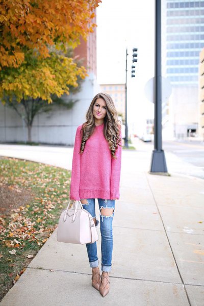 Pink chunky knit sweater with blue heavily ripped jeans