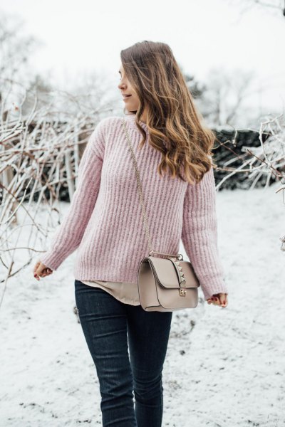 Blush a ribbed sweater with black coated slim fit jeans