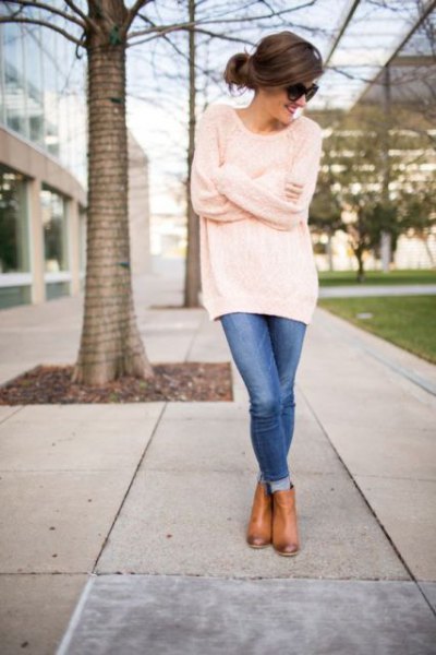 Oversized tunic sweater with cuffed blue skinny jeans and leather
boots