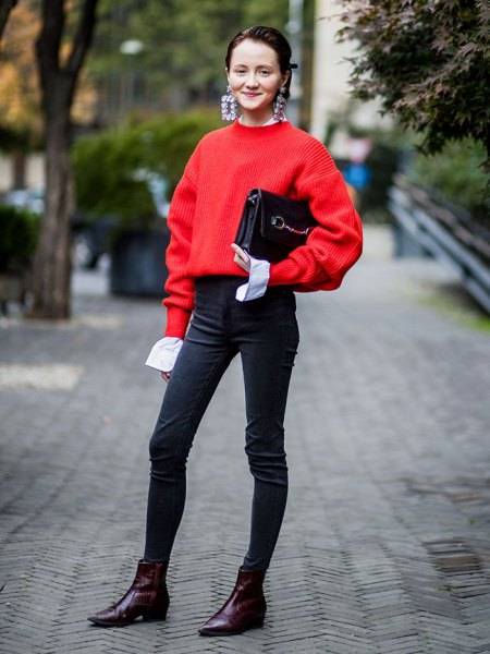 Red sweater with black high-waisted skinny jeans and ankle boots