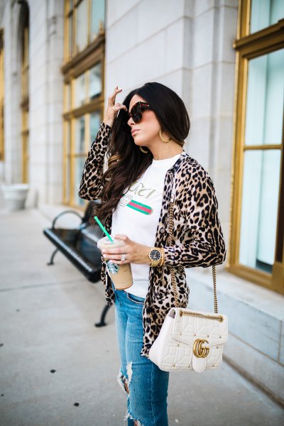 White t-shirt with leopard print jacket and ripped blue jeans