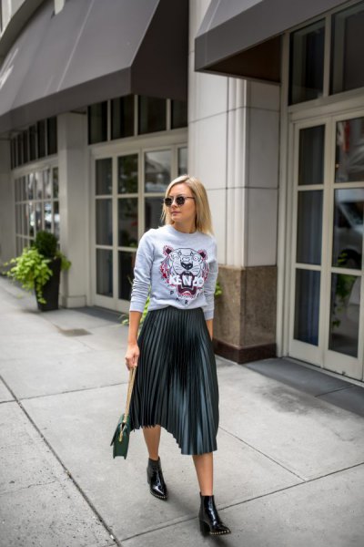 Light gray graphic sweater with black pleated midi skirt