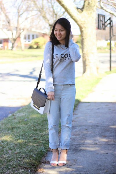 Sweater with light blue cuffed boyfriend jeans and pink open toe cropped boots