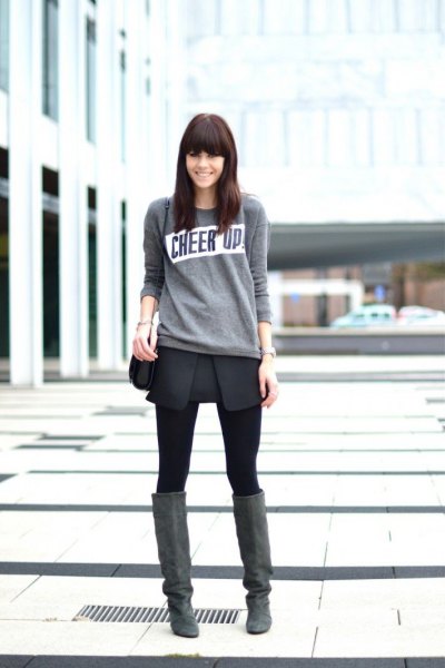 Light gray sweater with black mini wrap skirt and overknee suede
boots