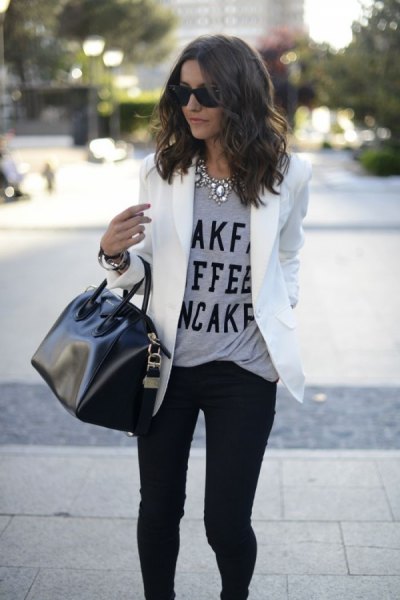 Gray message t-shirt with white blazer jacket and black skinny jeans
