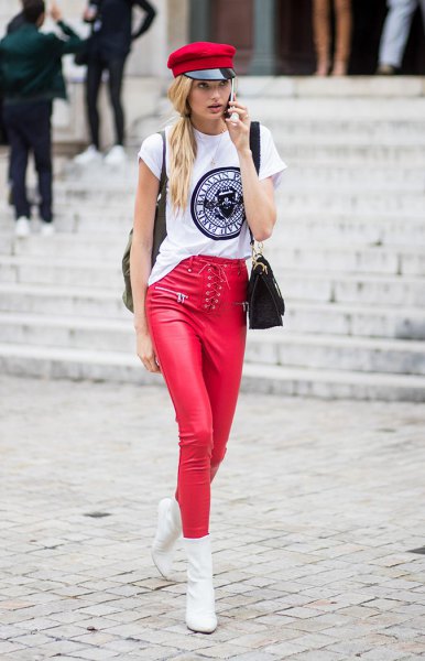 White cool graphic tee with red painter hat and matching leather leggings