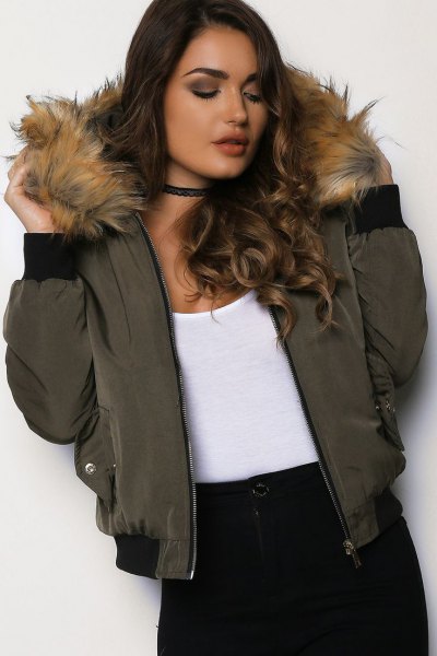 Green bomber jacket with fur hood, white tank top and black
collar