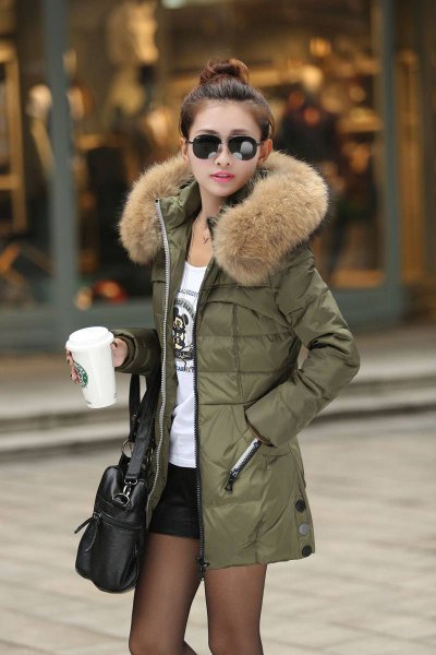Olive green long down jacket with fur hood, white printed t-shirt
and black mini shorts