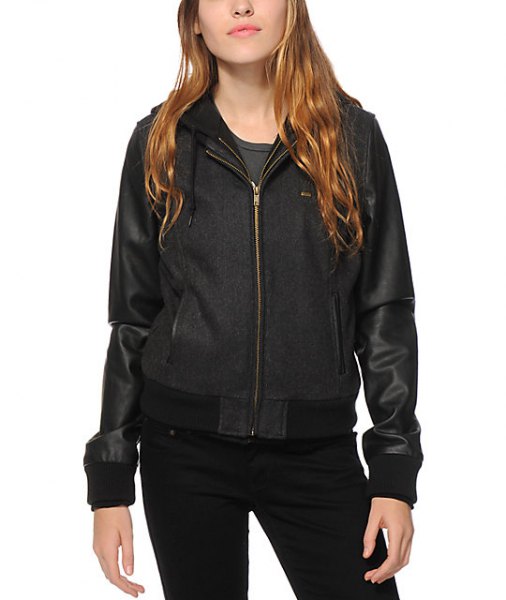 Black fleece and leather hooded two-tone bomber jacket paired with skinny jeans