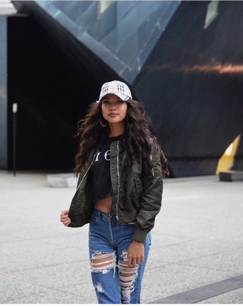 Black cropped t-shirt worn with an olive bomber jacket and ripped boyfriend jeans