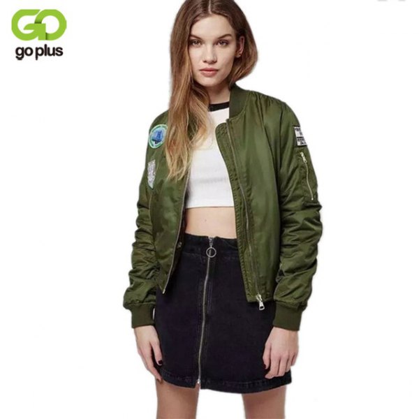 Embroidered olive green bomber jacket with white crop top and black high-rise skirt