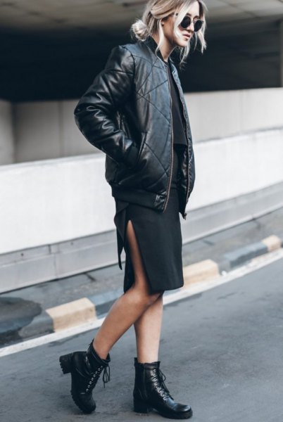 Black leather flight jacket with knee length dress with high slit