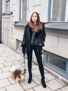 Black flight jacket with a gray chunky knit sweater and skinny jeans