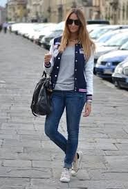 Navy blue and white varsity jacket with low top sneakers