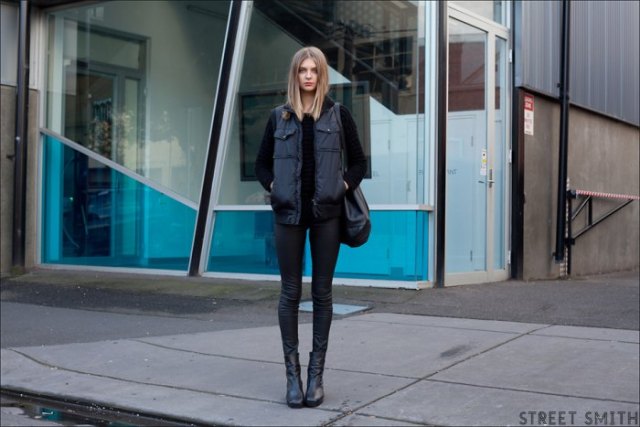 long black down vest with sweater and skinny jeans