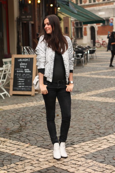 White shiny bomber jacket with all black outfit