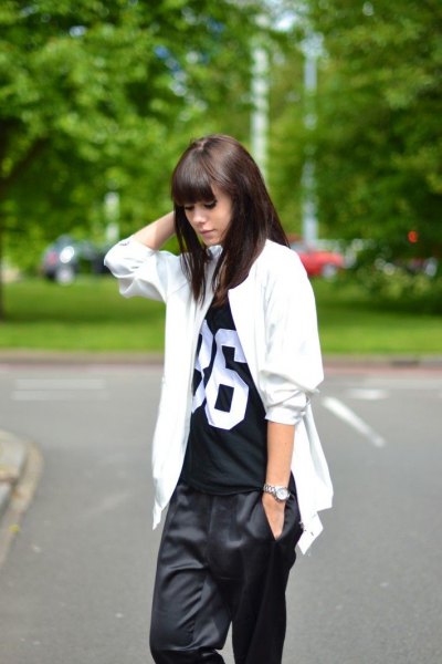 White oversized jacket with black printed t-shirt and baggy pants