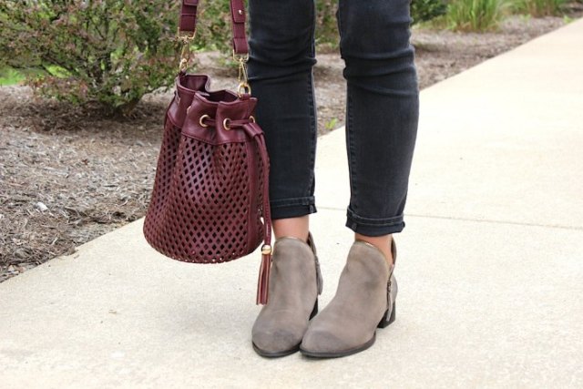 Soft leather burgundy handbag worn with white blouse and black ankle slim jeans