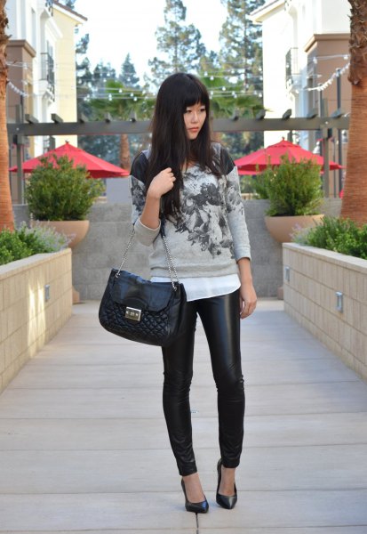 Gray printed sweater with white chiffon blouse and quilted black
leather handbag