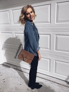 Gray blue button down shirt, black slim fit jeans and gray suede shoulder bag