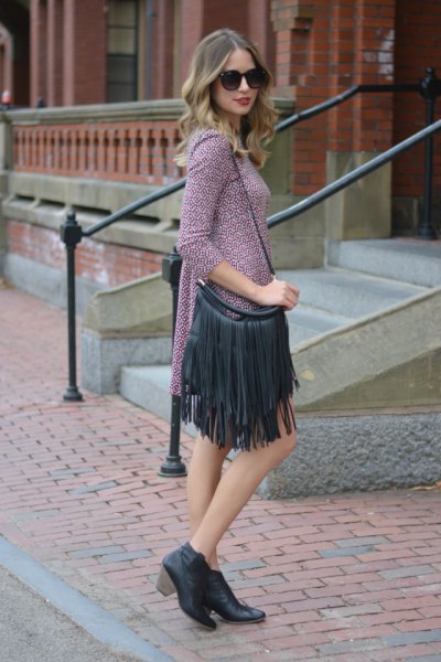 Gray knitted mini shift dress with three quarter sleeves and black leather fringed handbag