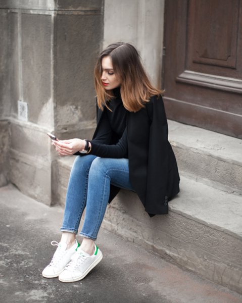 Black wool coat with a high neck sweater and ankle-length mom jeans