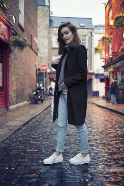 black long wool coat with gray turtleneck and white shoes