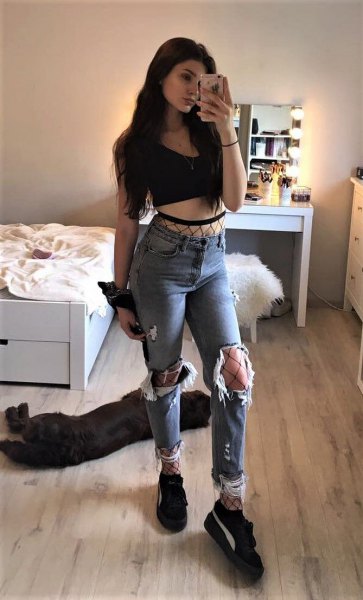Black cropped tank top with ripped boyfriend jeans and platform sneakers