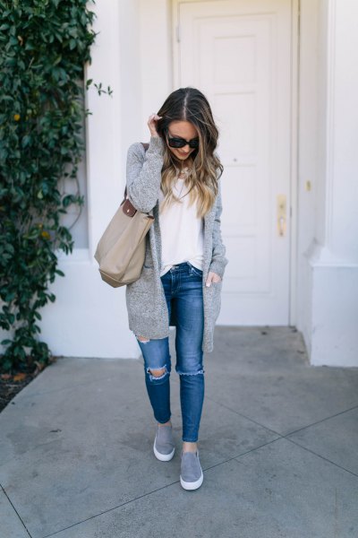 Long knit sweater cardigan with blue jeans and gray slip-on platform sneakers