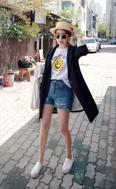 Black long cardigan with white printed t-shirt and blue denim shorts