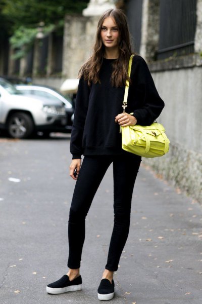 black crew neck knit sweater with lemon yellow leather shoulder bag
