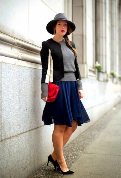 Black and white fitted blazer with dark blue skater dress and felt hat