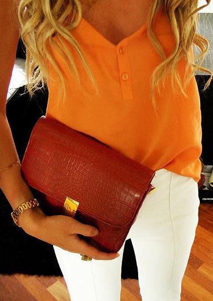 mustard yellow vest top with white skinny jeans and burgundy leather clutch