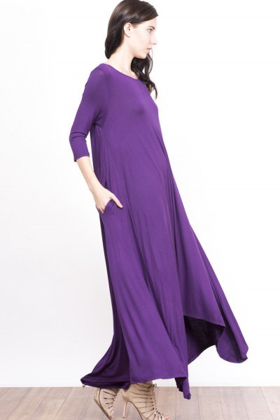 Purple, floor-length sheath dress with three-quarter sleeves and
bare strappy heels