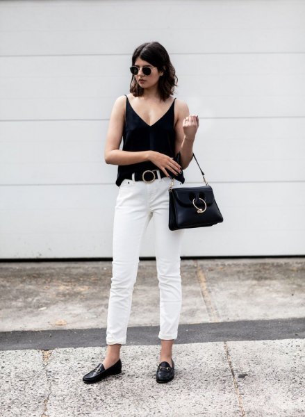 Black v-neck tank top, white cuffed straight-leg jeans and loafers