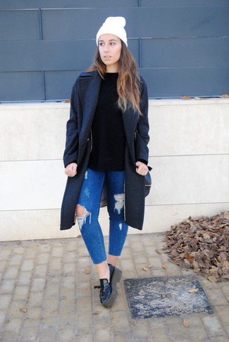 Black wool coat with blue ripped slim fit jeans and leather platform loafers