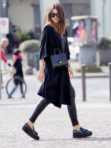 Black trench coat with half sleeves, leather leggings and loafers