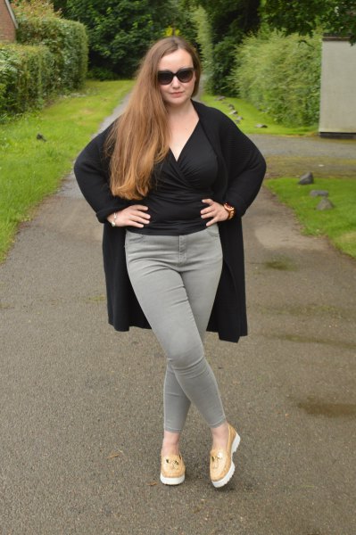 Black wrap blouse with gray slim fit jeans and pink loafers