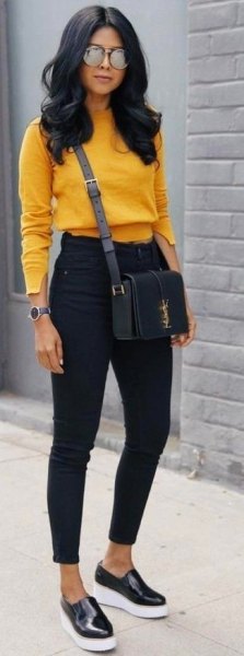 Team a mustard cropped knit sweater with black slim-fit jeans