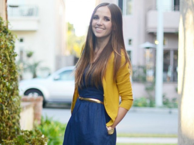 Lemon yellow cardigan with navy blue flared dress with gathered waist and belt