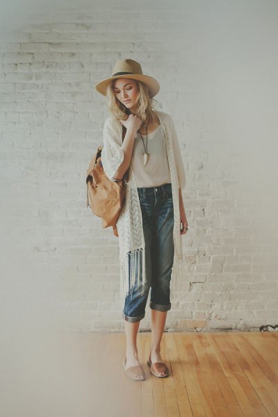 White longline cardigan with fringes, white straw hat and soft pink slide sandals