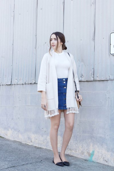 White fringed cardigan and blue denim mini skirt