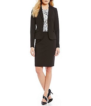 The black suit consists of a short coat and a pencil skirt