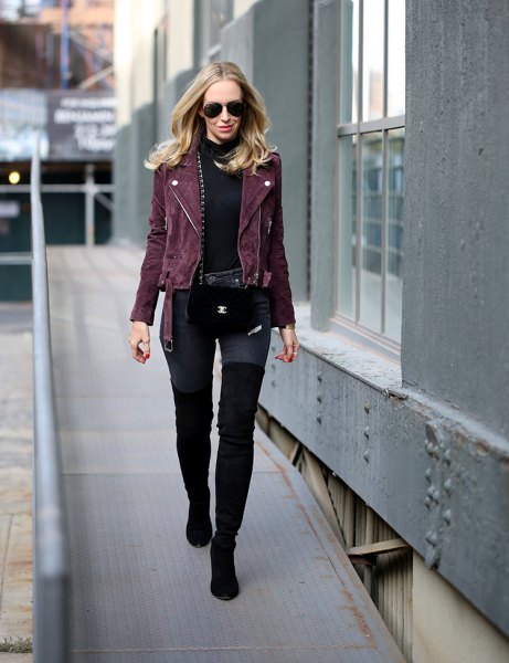 Black motorcycle jacket with a stand-up collar sweater and thigh-high boots